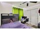 Bedroom featuring a ceiling fan, a bed, a desk with computer monitors and lime green curtains at 6383 Enclave Blvd, Greenwood, IN 46143