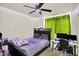 Bedroom featuring a ceiling fan, a bed, a desk with computer monitors and lime green curtains at 6383 Enclave Blvd, Greenwood, IN 46143