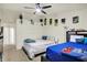 Bright bedroom showcasing two beds, ceiling fan, and neutral carpet at 6383 Enclave Blvd, Greenwood, IN 46143