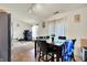 Dining area featuring a dark wood table, and tile flooring, bathed in natural light at 6383 Enclave Blvd, Greenwood, IN 46143