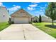 Lovely one-story home featuring a spacious driveway, attached garage, and manicured landscaping at 6383 Enclave Blvd, Greenwood, IN 46143
