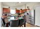 A bright kitchen is showcased with a stainless steel refrigerator and a marble top breakfast table at 6383 Enclave Blvd, Greenwood, IN 46143