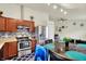 A cozy eat-in kitchen features wood cabinets, stainless steel appliances, and modern lighting at 6383 Enclave Blvd, Greenwood, IN 46143