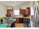 Eat-in kitchen with stainless appliances, wood cabinetry, and mosaic backsplash at 6383 Enclave Blvd, Greenwood, IN 46143