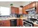 Eat-in kitchen features wood cabinets, stainless steel appliances and a gray mosaic backsplash at 6383 Enclave Blvd, Greenwood, IN 46143