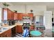 An eat-in kitchen features wooden cabinets, stainless appliances, and sleek mosaic backsplash tiles at 6383 Enclave Blvd, Greenwood, IN 46143