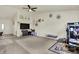 Open-concept living area with a ceiling fan, and carpet, connecting seamlessly to other spaces at 6383 Enclave Blvd, Greenwood, IN 46143