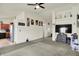 Open-concept living area with ceiling fan, carpet, and natural light, perfect for entertaining at 6383 Enclave Blvd, Greenwood, IN 46143