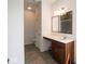 Well-lit bathroom features a single sink vanity, tiled floors, and toilet at 7241 Glen Park Ln, Indianapolis, IN 46259