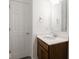 Bathroom featuring a sink with a modern faucet, mirror, and vanity lighting at 7241 Glen Park Ln, Indianapolis, IN 46259
