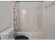 Bathroom with a shower and tub combination with white tile and a shower curtain at 7241 Glen Park Ln, Indianapolis, IN 46259