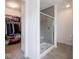 Bathroom showcasing a glass-enclosed shower and walk-in closet at 7241 Glen Park Ln, Indianapolis, IN 46259