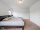 A carpeted bedroom is bright with natural light, featuring two beds, carpet, and neutral paint at 7241 Glen Park Ln, Indianapolis, IN 46259