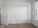 Bright bedroom with a sliding door closet and a window providing natural light at 7241 Glen Park Ln, Indianapolis, IN 46259