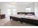 A carpeted bedroom is bright with natural light, featuring two beds and simple decor at 7241 Glen Park Ln, Indianapolis, IN 46259