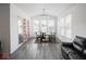 Bright dining area with large windows, stylish furniture, and modern lighting at 7241 Glen Park Ln, Indianapolis, IN 46259