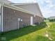 Exterior view of a brick home with green grass and an AC unit at 7241 Glen Park Ln, Indianapolis, IN 46259