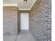 Entryway featuring a white front door framed by brick walls at 7241 Glen Park Ln, Indianapolis, IN 46259