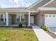 Charming front porch of brick home with a manicured flower bed along the walkway at 7241 Glen Park Ln, Indianapolis, IN 46259
