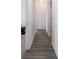 Hallway with wood-look flooring, neutral walls, and white trim at 7241 Glen Park Ln, Indianapolis, IN 46259