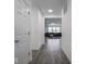 Hallway with wood floors leading to a bright living area and rooms at 7241 Glen Park Ln, Indianapolis, IN 46259