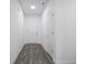 White hallway with hard wood floors, white doors, and baseboards at 7241 Glen Park Ln, Indianapolis, IN 46259