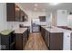 Modern kitchen featuring stainless steel appliances, marble countertops, and ample cabinet space at 7241 Glen Park Ln, Indianapolis, IN 46259