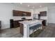 Open kitchen with marble countertops, breakfast bar, and stainless steel appliances at 7241 Glen Park Ln, Indianapolis, IN 46259