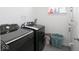 A laundry room with newer black appliances and luxury vinyl plank flooring at 7241 Glen Park Ln, Indianapolis, IN 46259