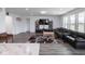 Bright living space with modern furnishings, entertainment center, and seamless flow to other rooms at 7241 Glen Park Ln, Indianapolis, IN 46259