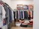 Spacious walk-in closet with clothing and bedding neatly arranged on shelves at 7241 Glen Park Ln, Indianapolis, IN 46259