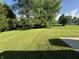 Large backyard with lush lawn and mature trees providing privacy and shade at 7313 Shanna Cir, Indianapolis, IN 46236