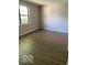 Bedroom with a large window and durable wood vinyl plank flooring at 7313 Shanna Cir, Indianapolis, IN 46236