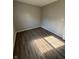 Empty bedroom featuring natural light and newly installed laminate flooring at 7313 Shanna Cir, Indianapolis, IN 46236