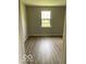 A bedroom showing the laminate floor, freshly painted walls, and window at 7313 Shanna Cir, Indianapolis, IN 46236