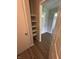 Entryway with a closet featuring built-in shelving, neutral walls, and wood-look flooring at 7313 Shanna Cir, Indianapolis, IN 46236