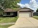 Charming single-story home with a two-car garage, stone accents, and a well-manicured lawn at 7313 Shanna Cir, Indianapolis, IN 46236