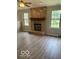 Living room featuring a floor-to-ceiling stone fireplace and hardwood flooring at 7313 Shanna Cir, Indianapolis, IN 46236
