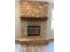Close-up of a floor-to-ceiling stone fireplace with a wooden mantle and hearth at 7313 Shanna Cir, Indianapolis, IN 46236