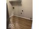 Laundry room area featuring laminate flooring and utility hookups at 7313 Shanna Cir, Indianapolis, IN 46236