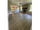 Spacious living room featuring a stone fireplace, wood-look floors, and windows providing natural light at 7313 Shanna Cir, Indianapolis, IN 46236