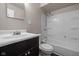 This bathroom features a shower-tub combo with a dark wood vanity at 7424 North Dr, Lawrence, IN 46226