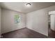 This bedroom has neutral walls and a large window with natural light at 7424 North Dr, Lawrence, IN 46226