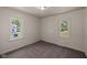 Clean bedroom with carpeted flooring, and dual windows offering natural light at 7424 North Dr, Lawrence, IN 46226