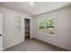 Comfortable bedroom with carpet flooring, built-in shelving, and a sunny window view at 7424 North Dr, Lawrence, IN 46226