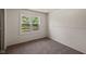 Cozy bedroom with plush carpet, neutral walls, and natural light from the window at 7424 North Dr, Lawrence, IN 46226