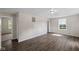 Bright living room with wood-look flooring, neutral walls, and ample natural light from the window at 7424 North Dr, Lawrence, IN 46226