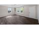 Inviting living room with new wood-look flooring, fresh paint, and natural light at 7424 North Dr, Lawrence, IN 46226