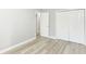 A bedroom featuring gray walls, light wood floors, doorway, and closet at 7643 S Delaware St, Indianapolis, IN 46227