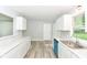 Bright kitchen with white cabinets, modern countertops, vinyl floors, and ample natural light at 7643 S Delaware St, Indianapolis, IN 46227